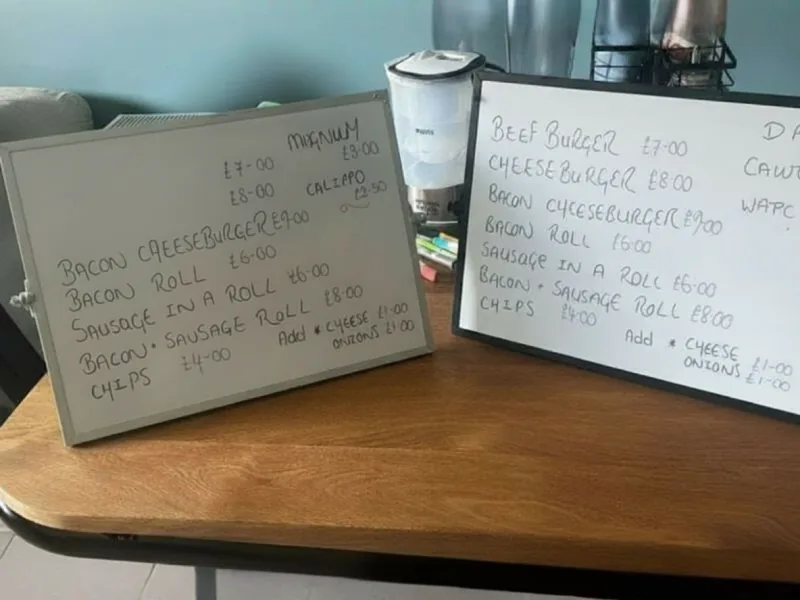 PremierPlus street food menu boards showing burgers, halloumi pitta, sides and drinks with prices