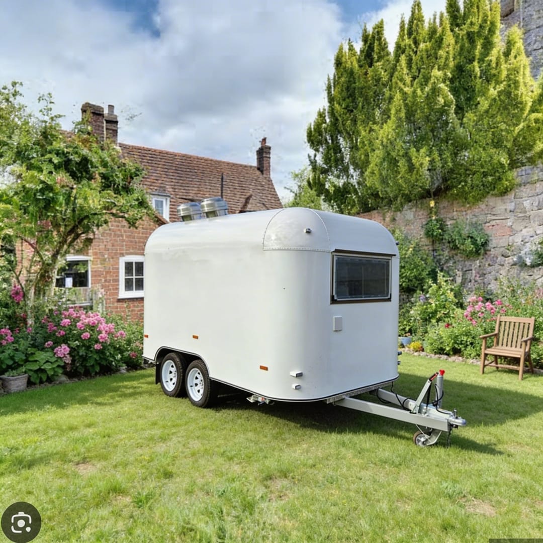 White catering trailer in a garden setting